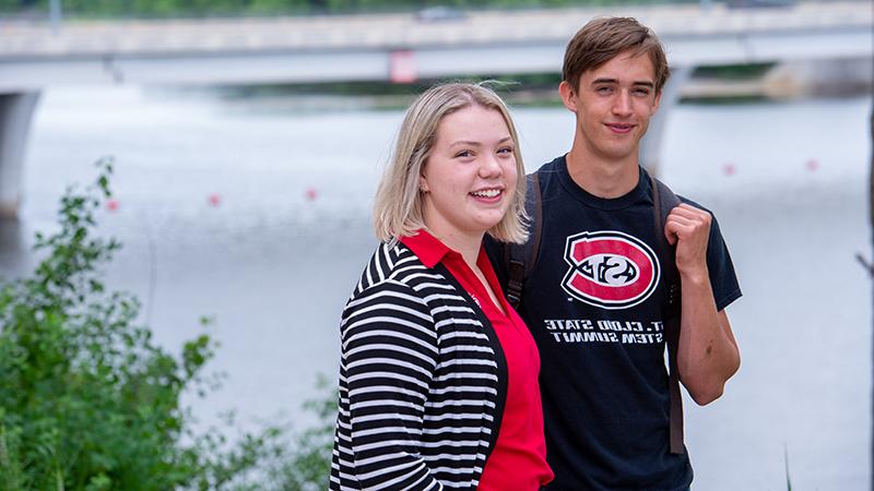 Two students by river